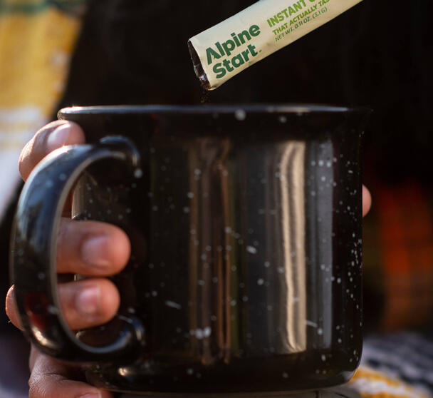 Alpine Start Cozy Beverages collection featuring instant coffee, creamer, dirty chai latte, hot cocoa, and cocktail mixers like hot toddy, spiked cider, and old fashioned β easy drinks for camping trips or relaxing days at home.